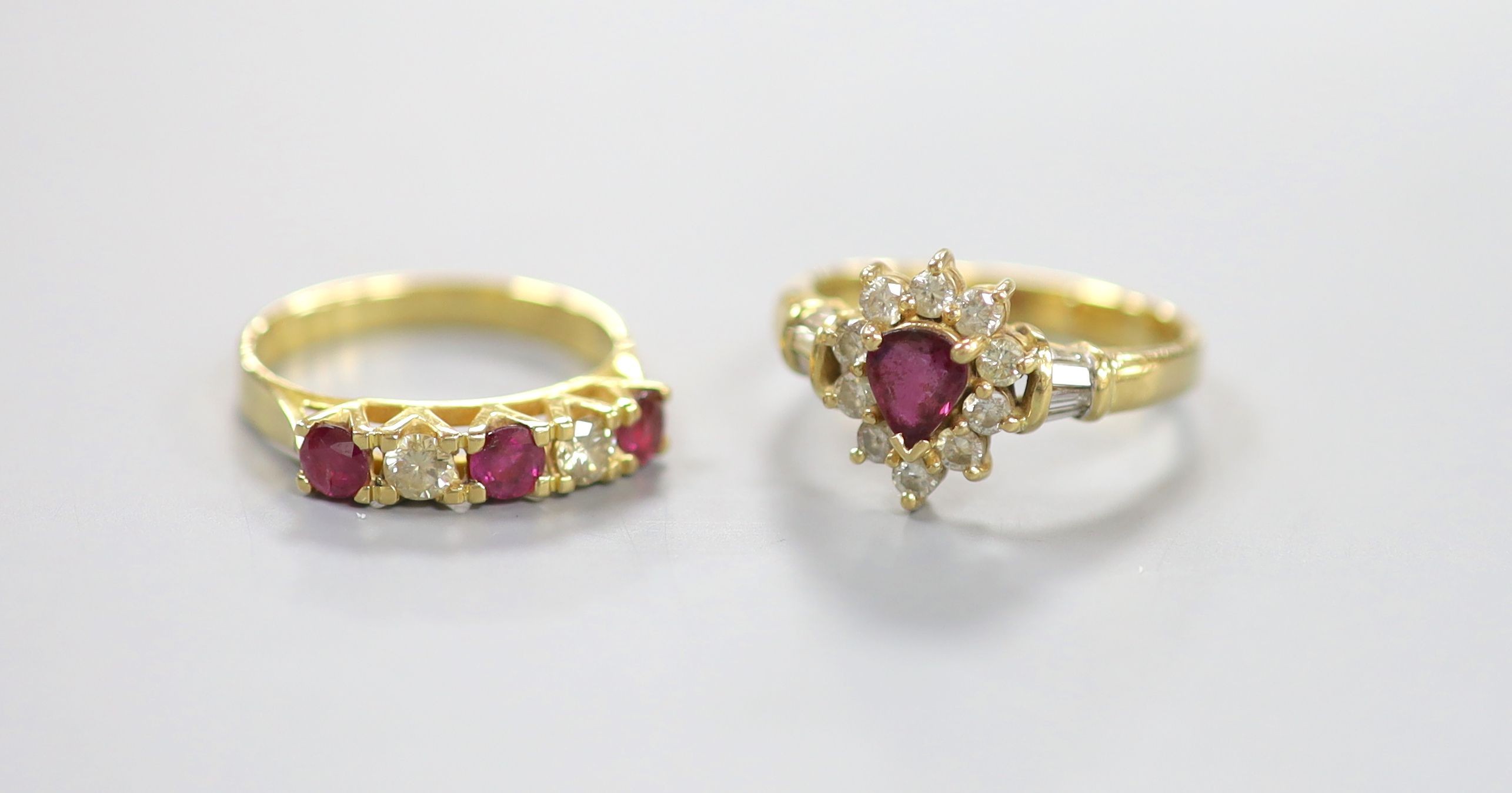 Two modern 18k, ruby and diamond dress rings, including pear shaped cluster and half hoop, sizes Q & P, gross 9.3 grams.